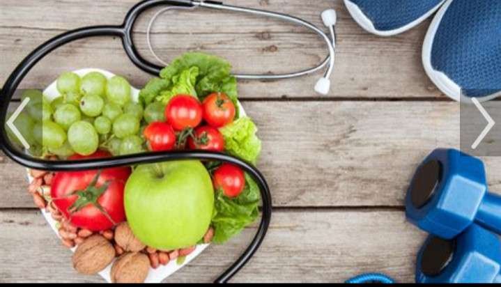 A PICTURE OF FRUITS ON A TABLE WITH A STETHOSCOPE LAID ON TOP