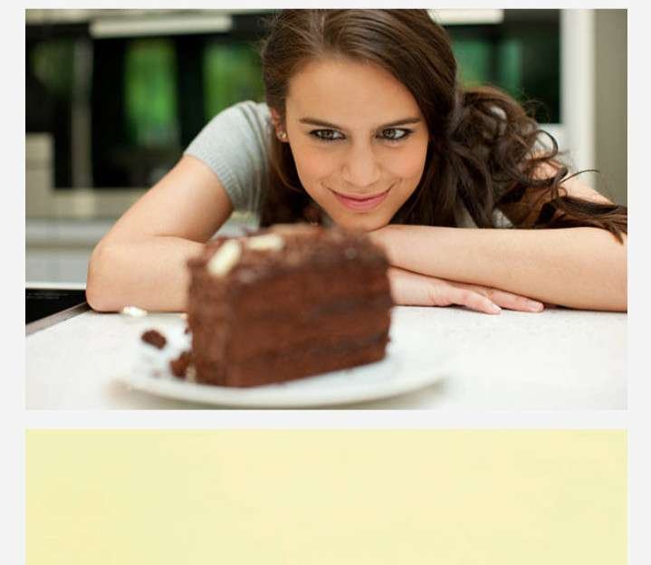 GIRL SITTING AT A TABLE - BEING TEMPTED BY PIECE OF CHOCOLATE CAKE