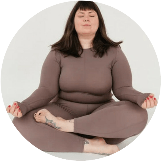 OVERWEIGHT GIRL SITTING INDIAN STYLE DOING YOGA IN BROWN LEOTARD ONEPIECE