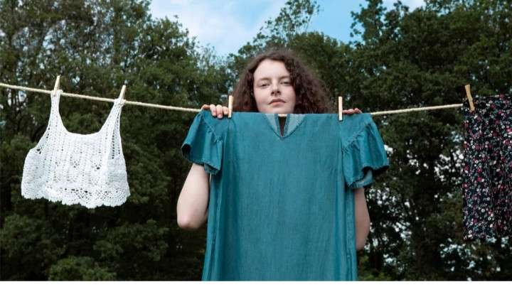 GIRL STANDING IN FRONT OF A CLOTHES LINE - ASHAMED OF HER BODY IMAGE