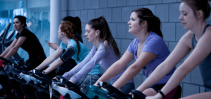 GROUP OF 5 WOMEN. EACH ON THEIR OWN TREADMILL.