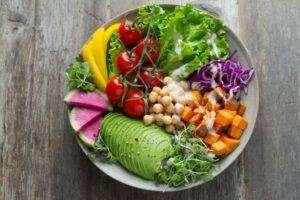 PLATE FULL OF NUTRITIOUS COLORFUL HEALTHY FRUITS AND VEGETABLES