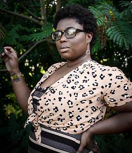 PLUS SIZE MODEL MAYBE GHANIAN - WEARING A PINK AND BLACK PRINTED WRAP AROUND TOP AND HIGH WAISTED BOTTOM