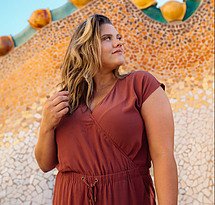 women in rust colored dress contemplating weight loss