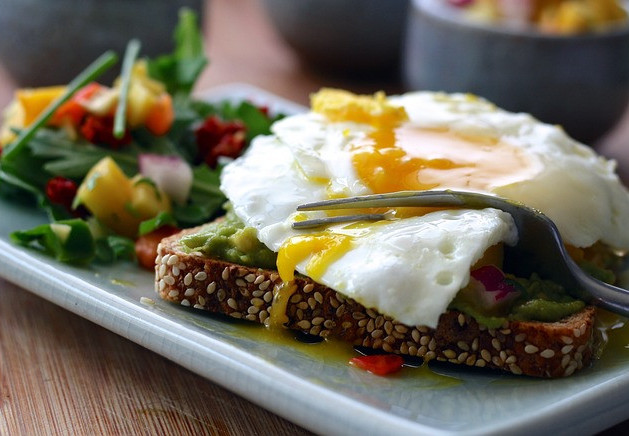 LARGE PLATE FULL OF NUTRITIOUS FOOD SUCH AS VEGETABLES, EGGS, MEAT