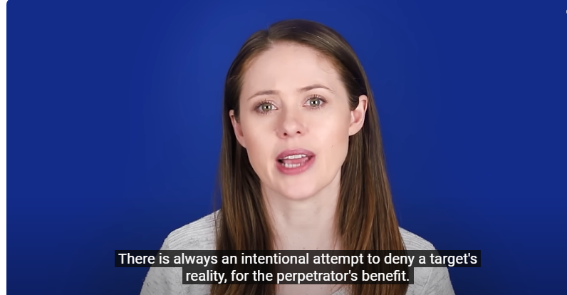 Picture of a young female speaker with long brown hair talks about how gaslight is intentional. Thr background is medium blue color.