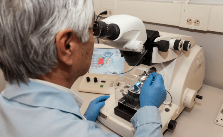 MEANING OF GENETICALLY DISPOSED GENE SPECIALISTS EXAMINING GENES UNDER A MICROSCOPE