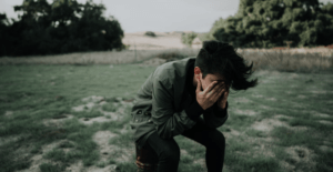 YOUNG BOY COVERING HIS FACE FROM HEAT EXHAUSTIAN