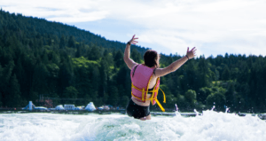 A SWIMMER WEARING A LIFE JACKET LEARNING WATER SAFETY TIPS FOR THE SUMMER