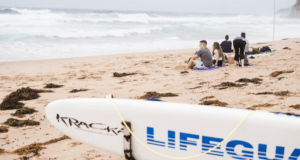 BEACH GOERS ADHERING TO THE WATER SAFETY TIPS FOR SUMMER AS LIFEGUARD STANDS BY