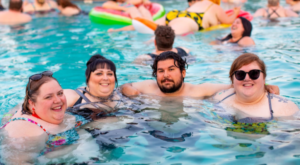 GROUP OF MORBIDLY OBESE FRIENDS ENJOYING A SWIM