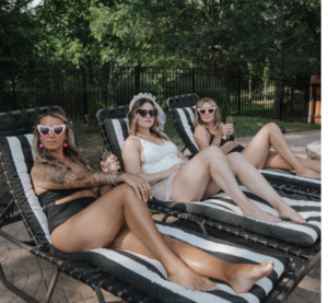 THREE YOUNG LADIES CHILLING IN LAWN CHAIRS IN THE BACKYARD