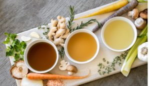 IMAGE OF THREE CUPS OF THE BEST HERBAL TEAS ON A SERVING TRAY WITH GARNISHES ON THE SIDES