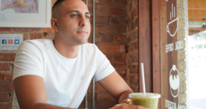 YOUNG MAN ENJOYING HIS MATCHA SMOOTHIE