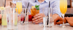 GUY IN LIGHT BLUE SHIRT SIPPING A NON-ALCOHOLIC BEVERAGE