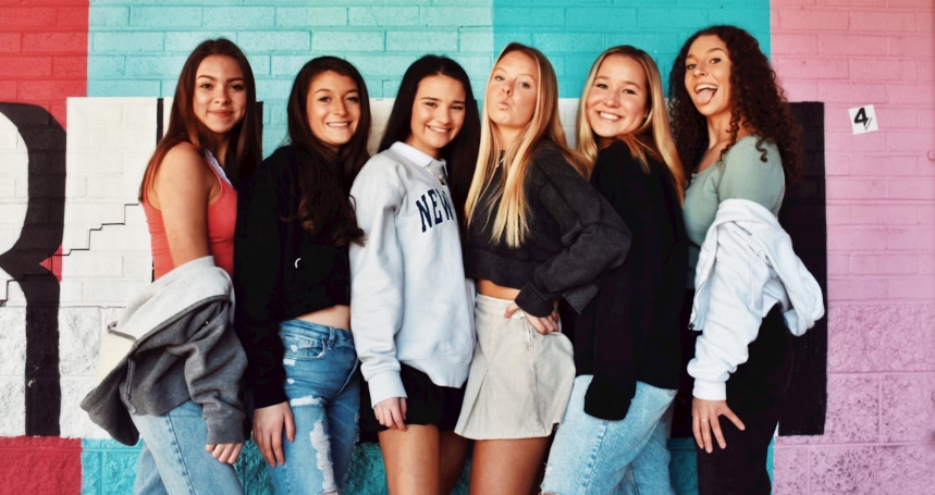 A GROUP OF YOUNG WOMEN STANDING FOR WOMEN'S HEALTH IN A PHOTO SHOOT